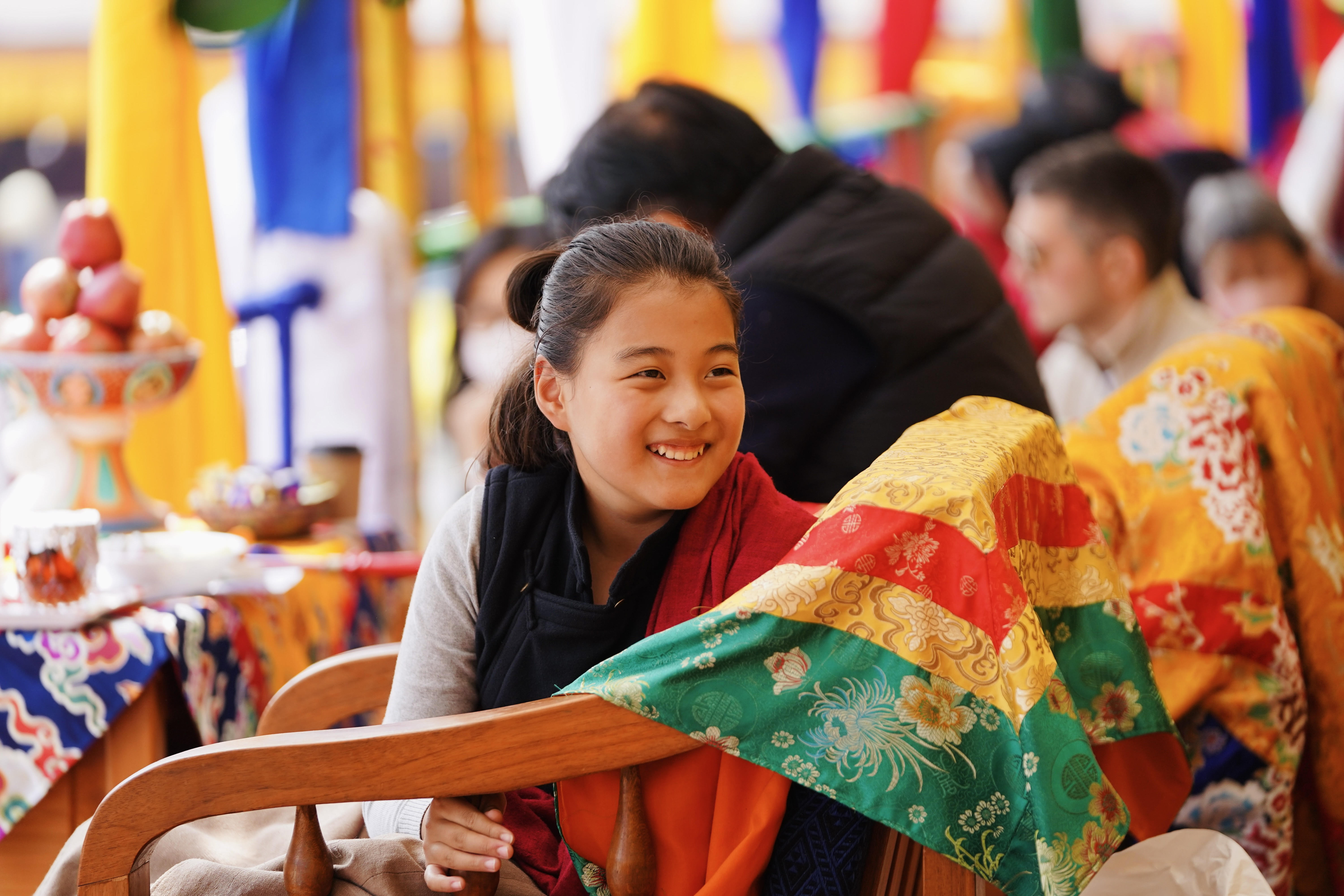 Yangsi Gyana Ta Sitting in Chair Smiling Gyanta